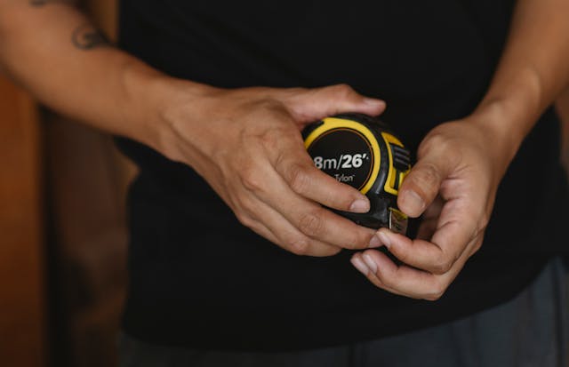 A contractor holding a measuring tape