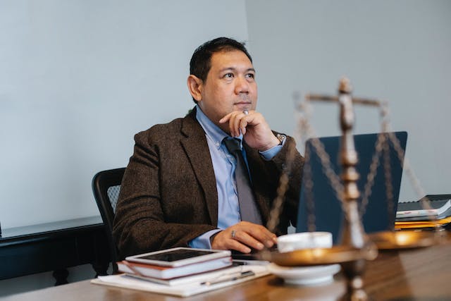 a judge sitting at their desk with a legal balance on it